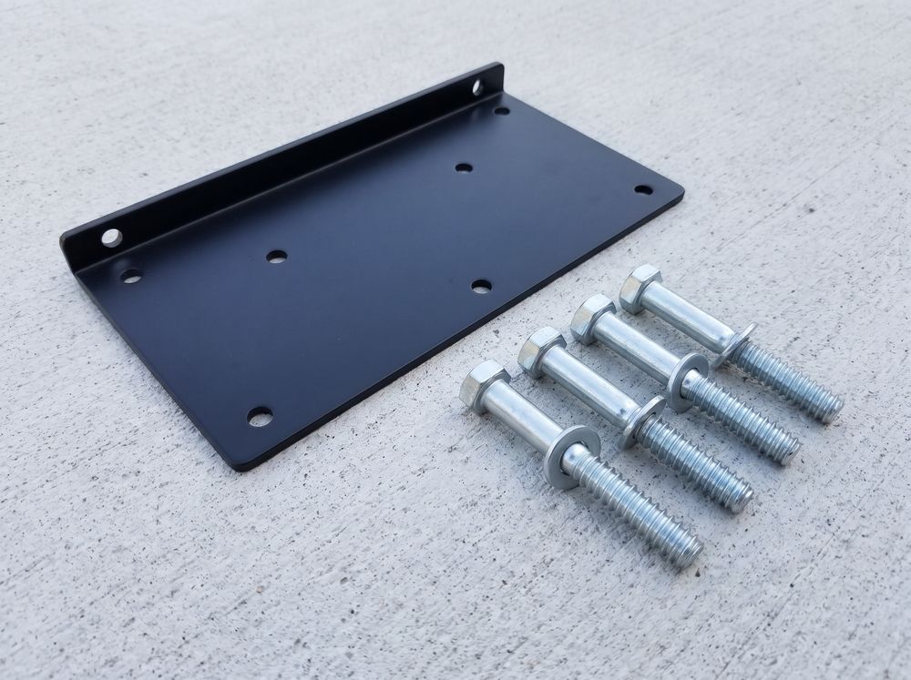 A steel TV wall-mount plate with lag bolts and washers beside it